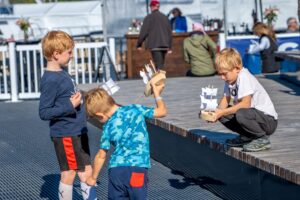 kids playing with wooden boats